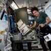 NASA astronaut Jessica Meir performs in-flight maintenance on the Major Constituent Analyzer Mass Spectrometer the International Space Station.